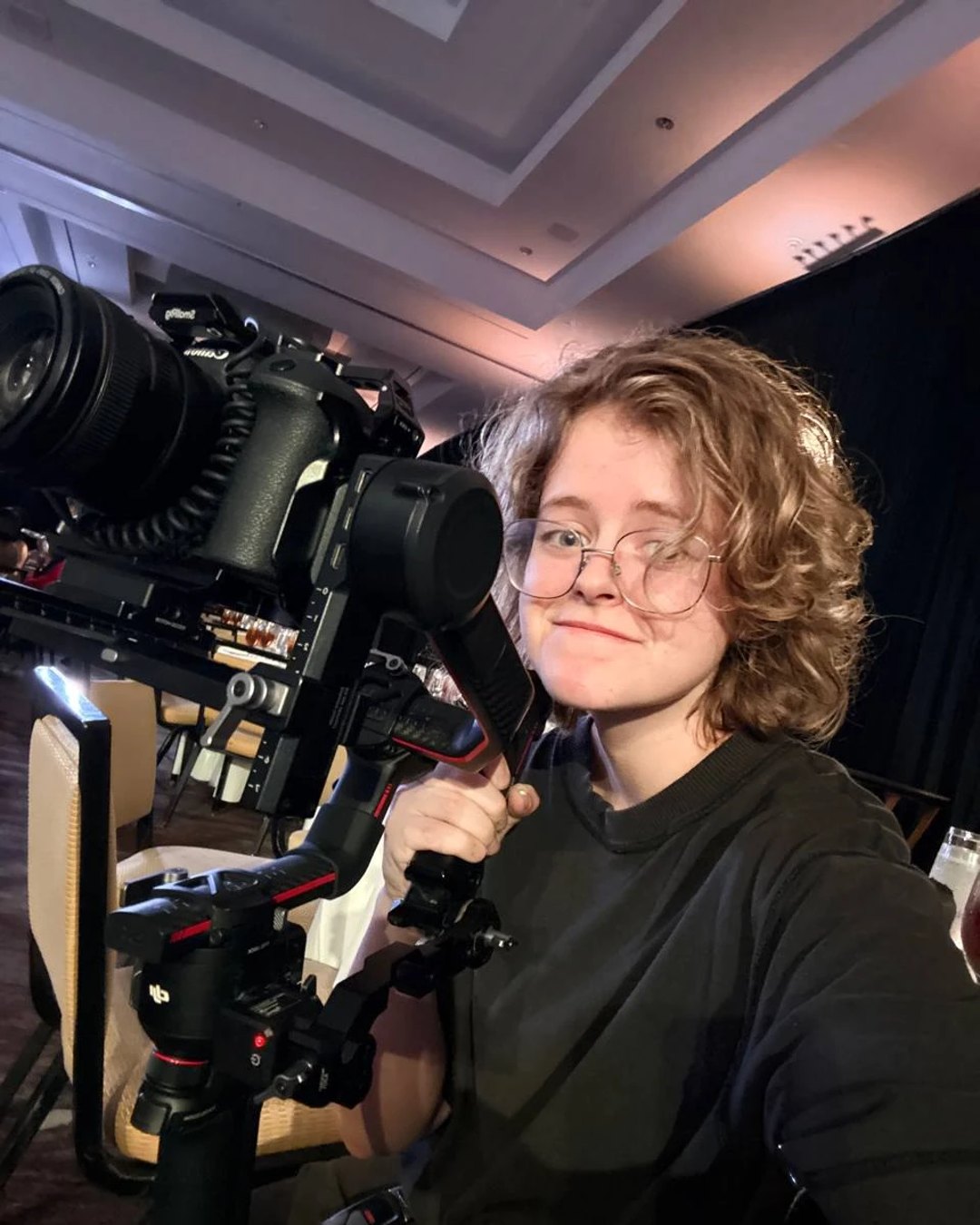 Alisa on set, camera in hand