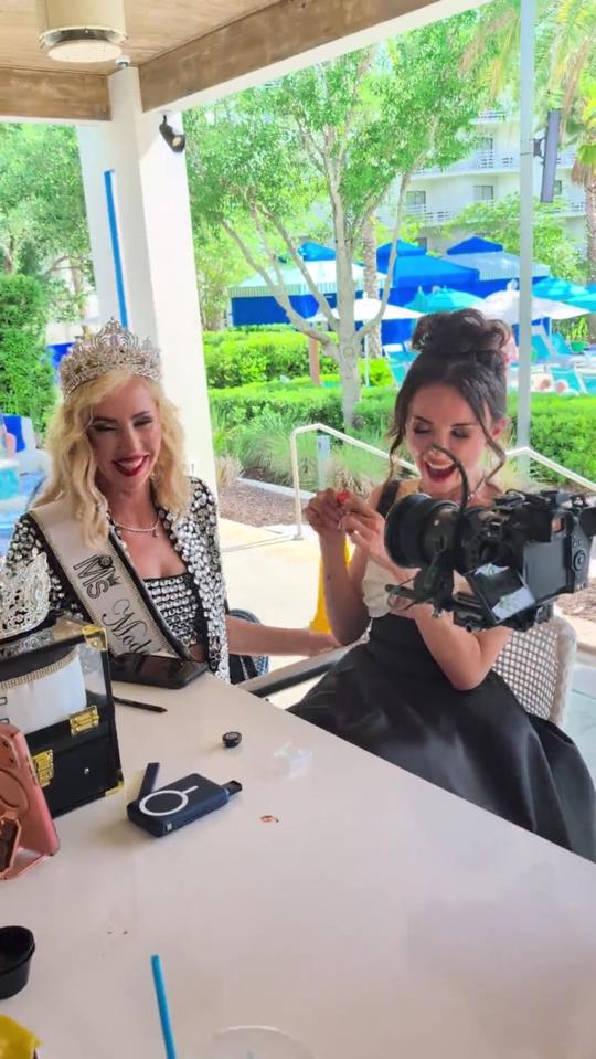 Film crew backstage with a crowned model