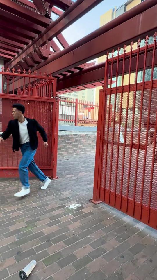 Alisa filming a model through a red gate