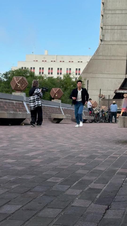 Alisa with a gimbal, filming on a plaza