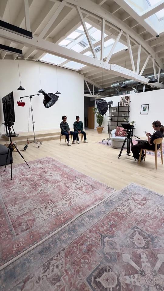 Studio set with lights, two people on chairs